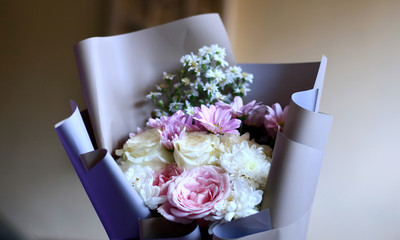 Hand holding a bouquet of flowers.