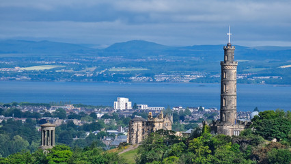 Fototapeta na wymiar Aerial summer view of Edinburgh Scotland, with Calton Hill and its famous landmarks such as the Nelson Monument, National Monument of Scotland and Dugald Stewart Monument
