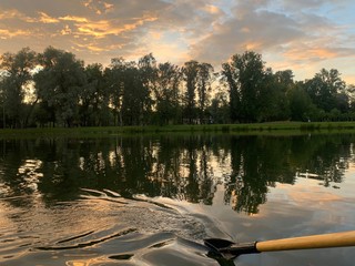 Sunset at the lake, sky reflection on the sea water
