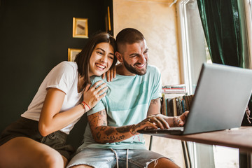 Young couple working in a coffee shop with the laptop