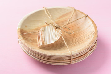 Betel palm leaf plate (Biodegradable plate, Compostable plate or Eco friendly disposable plate) on pink background