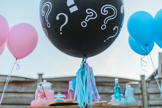 Gender reveal party with balloons.  