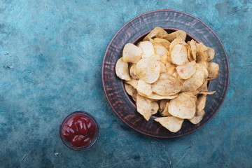 Potato chips in a bowl, beer snacks on a table