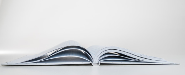 An expanded notebook for notes. Selective focus. Blurred background.