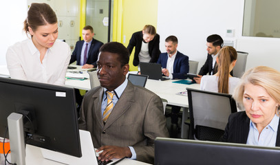 Business people working and communicating together in modern open plan office