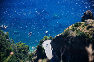 Amalfi Coast - Detail of Hairpin bend, cliff, turquoise sea and boats. View from Sentiero degli Dei - Path of Gods.