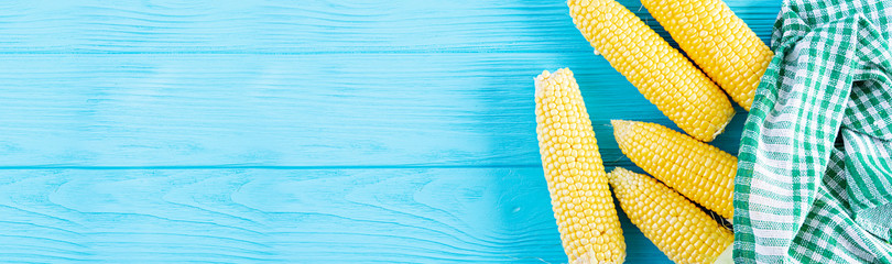 Fresh juicy corn isolated on wooden background. Grain crops concept