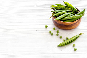 Sweet green peas in bowl on kitchen table desk