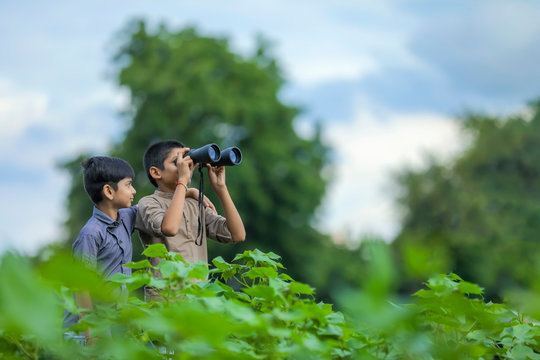 Tow Little Indian Boy Enjoys In Nature With Binoculars