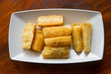 Deep fried cassava root . Brazilian Mandioca Frita (deep fried cassava/ manioc/yuca). Feijoada side...