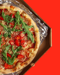 Appetizing pizza on a colored background. A look from above. A large snuil.