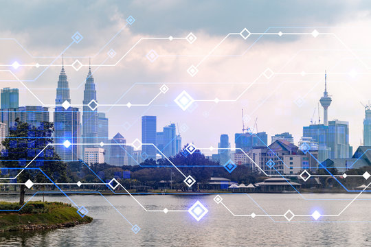 Glowing hologram of technological process, aerial panoramic cityscape of Kuala Lumpur at sunset. KL is the largest innovative hub of tech services in Malaysia, Asia. Multi exposure.