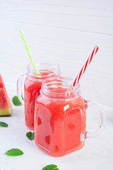 Fresh delicious watermelon smoothie with ice on white background