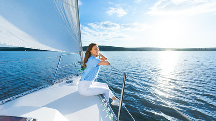 Relaxed Woman Sitting On Yacht Having Sailboat Ride In Sea