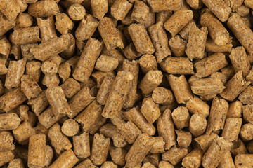 Brown wood pellets texture background. natural pile of wood pellets. organic biofuels. Alternative biofuel from sawdust. The cat litter. pile of compressed wood pellets.