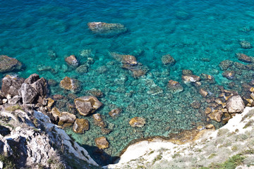 Aerial view of rocks on the sea. Overview of the seabed seen from above, transparent water