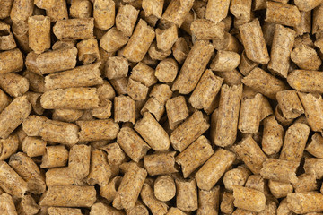 Brown wood pellets texture background. natural pile of wood pellets. organic biofuels. Alternative biofuel from sawdust. The cat litter. pile of compressed wood pellets.