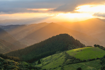 Fototapeta premium Sunset from Mount Ubieta, with the sun through the clouds