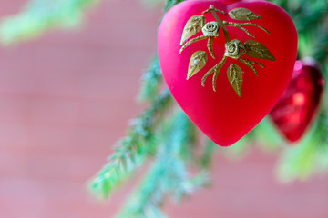 Red heart on christmas tree as holiday decoration