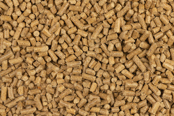 Brown wood pellets texture background. natural pile of wood pellets. organic biofuels. Alternative biofuel from sawdust. The cat litter. pile of compressed wood pellets.