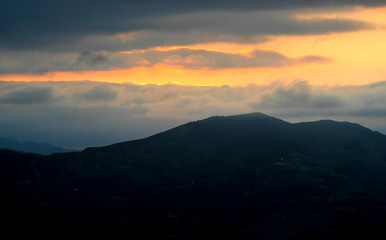 Sunset from Mount Ubieta, with the sun through the clouds