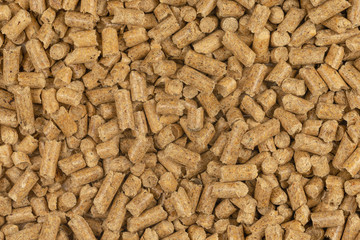 Brown wood pellets texture background. natural pile of wood pellets. organic biofuels. Alternative biofuel from sawdust. The cat litter. pile of compressed wood pellets.
