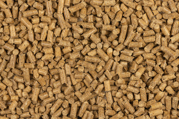 Brown wood pellets texture background. natural pile of wood pellets. organic biofuels. Alternative biofuel from sawdust. The cat litter. pile of compressed wood pellets.