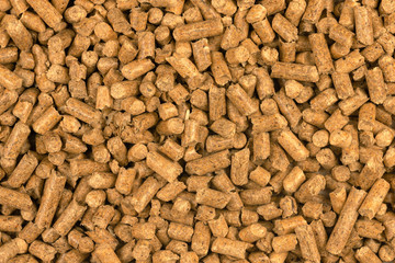 Brown wood pellets texture background. natural pile of wood pellets. organic biofuels. Alternative biofuel from sawdust. The cat litter. pile of compressed wood pellets.