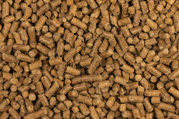Brown wood pellets texture background. natural pile of wood pellets. organic biofuels. Alternative biofuel from sawdust. The cat litter. pile of compressed wood pellets.