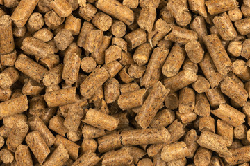 Brown wood pellets texture background. natural pile of wood pellets. organic biofuels. Alternative biofuel from sawdust. The cat litter. pile of compressed wood pellets.