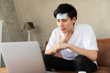 Young man Video chatting With his Doctor at home.