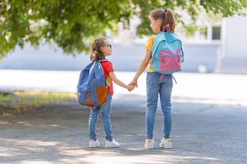 Girls with backpack are going to school