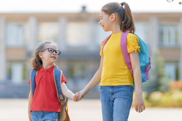 Girls with backpack are going to school