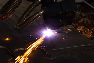 Sparks when cutting metal with a plasma machine at an industrial plant. 
