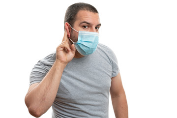 Listening gesture by man touching ear covering nose and mouth