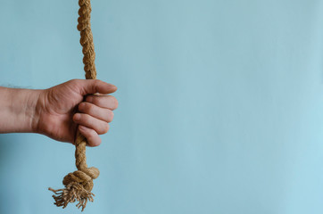 Hemp rope in a man's hand.