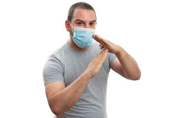 Adult making timeout gesture with hands wearing medical mask