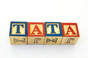 The term tata visually displayed on a clear background using colored wooden blocks image with copy...
