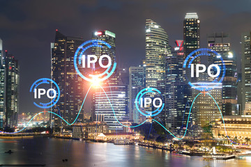 Initial public offering hologram, night panoramic city view of Singapore. The financial center for multinational corporations in Asia. The concept of boosting the growth by IPO process.