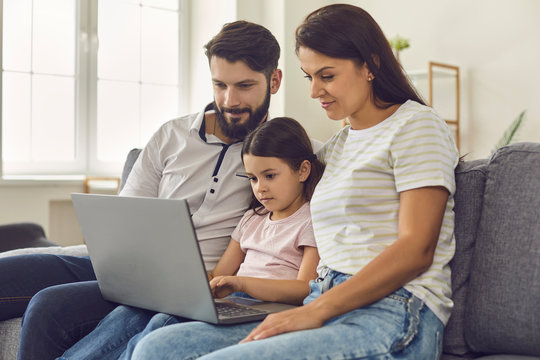 Family With Daughter Waiting Video Call For Online Doctor Consultation On Laptop At Home