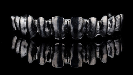 ideal titanium bar for creating a permanent upper jaw prosthesis, creative photography on black...