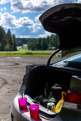 Cups of tea on car trunk on a standstill at car trip on a wonderful day