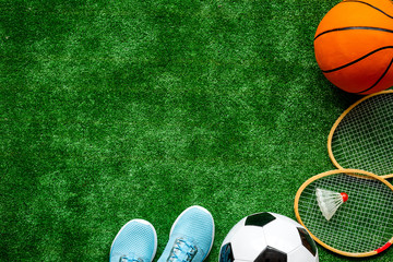 Obraz premium Frame of sport balls - football, basketball on football field. Copy space
