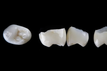 macro photo of dental veneers tabs on the teeth, top view on a black background