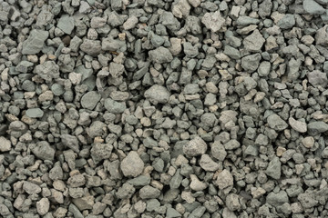 Gray small rocks ground texture. black small road stone background. gravel pebbles stone seamless texture. dark background of crushed granite gravel, close up. clumping clay