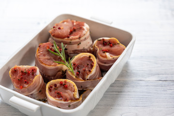 pork tenderloin in bacon on pepper