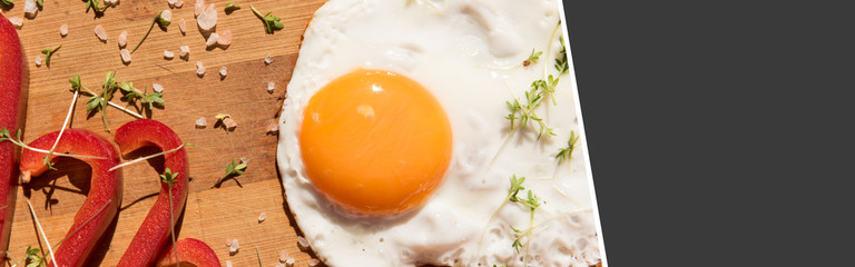 
fried egg on wooden board with space for text