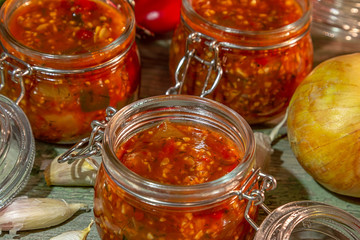 Autumn homemade preserved vegetables in glass jars.  Vegetable summer snack. Vegetarian food concept, copy space.