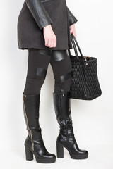 fashionable black boots with a handbag