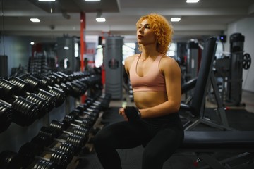 Fototapeta na wymiar Close up image of attractive fit woman in gym